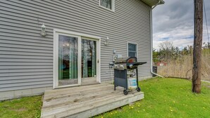 A house with a wooden deck, a barbecue grill, and a gas tank. - Fire Pit & Grill! Spacious Port Huron Home By Dtwn (Port Huron)