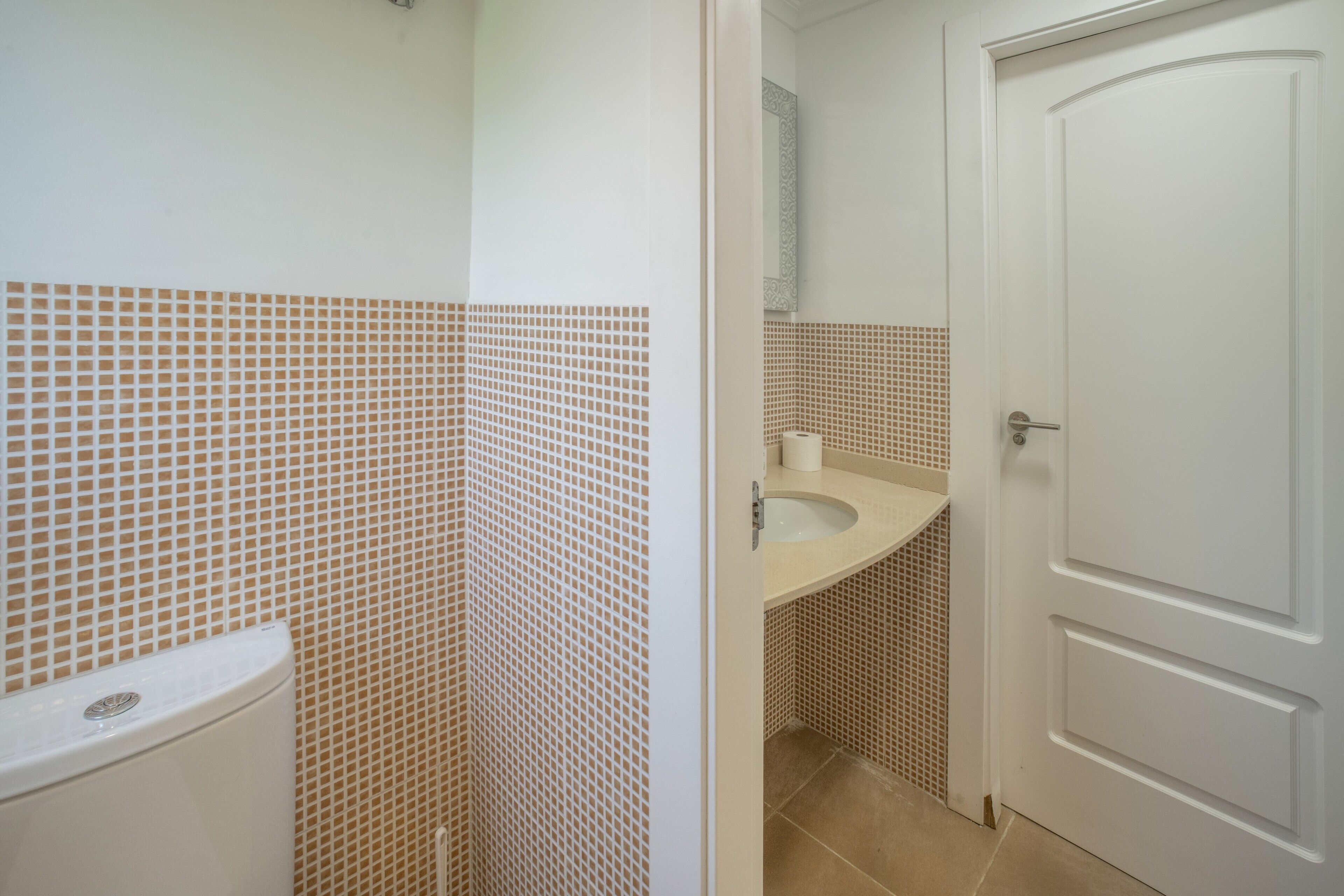 A bathroom with a toilet, sink, and shower area.