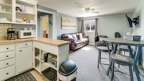 A compact living space with a kitchenette, a dining area, and a seating area with a couch and chairs. - Explore Port Huron! Cozy Condo w/ Creek Views (Port Huron)