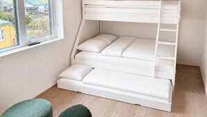 A bunk bed with a window, wooden flooring, and a view of houses outside. - Hvanngarðs Smáttan við Stórá (Dalur)