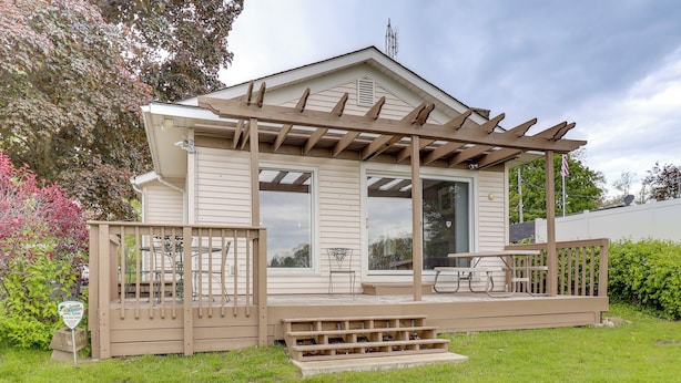 A single-story house with a covered porch, a small deck, and a front door. - Lake Webster Retreat: Pier, Kayaks & Fire Pit (North Webster)