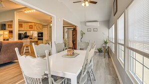 A dining area with a white table, chairs, and a ceiling fan. - < 1 Mi to Sand! Family-friendly Surfside Beach Gem (Murrells Inlet)