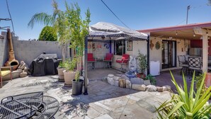A patio area with outdoor seating, a barbecue grill, and potted plants. - Outdoor Sanctuary + Gym! Retreat 4 Mi to Reid Park (Tucson)