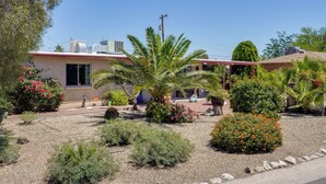 A residential property with a house, a garden with various plants and flowers, and a clear blue sky. - Outdoor Sanctuary + Gym! Retreat 4 Mi to Reid Park (Tucson)