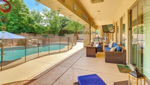 A covered outdoor area with a pool, seating, and a sign reading 'happy place.' - Pool, Hot Tub, Toys! Family Home, 4 Mi to Luke AFB (Litchfield Park)