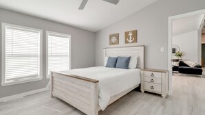 A bedroom with a bed, bedside table, and a mirror. - Walk to Yacht Club! Devils Lake Escape (Manitou Beach)