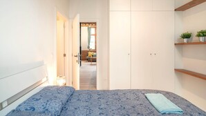 A bedroom with a bed, a wardrobe, and a hallway leading to another room. - Apartment for 6 With Antwerp City Views (Antwerp)