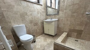 A bathroom with a toilet, sink, and shower area. - Vila Naty (Mamaia-Sat)