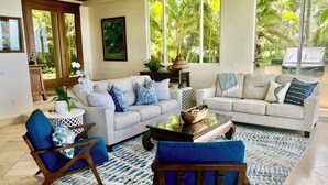 A living room with two sofas, a coffee table, and a blue patterned rug. - Beachfront / Oceanfront Private Home  Sleeps 8 (Wailea)