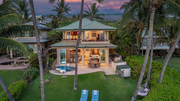 A two-story house with a pool, outdoor seating, and palm trees. - Beachfront / Oceanfront Private Home  Sleeps 8 (Wailea)