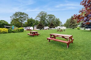 A grassy area with picnic tables and a gazebo. - Sandy Heart: Holiday House M18 (Wells)