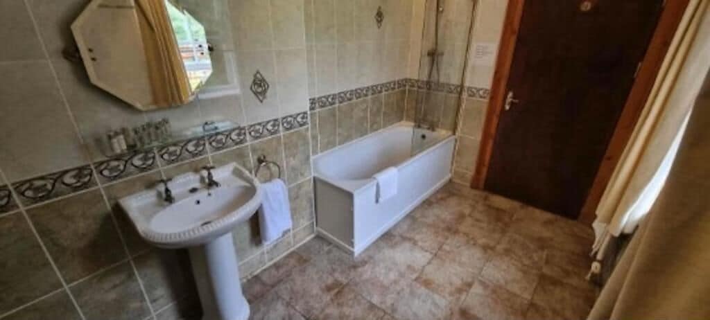 A bathroom with a sink, bathtub, and shower.