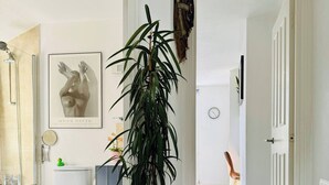 Une salle de bain équipée de toilettes, d’un lavabo, d’un miroir et d’une œuvre d’art encadrée accrochée au mur.