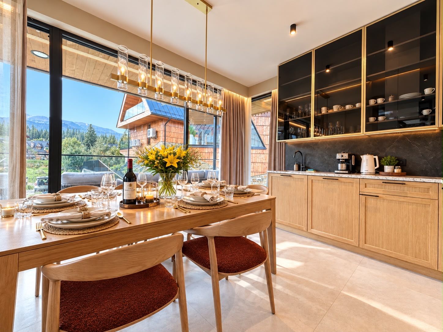 A modern kitchen with wooden cabinets and a dining area with a table set for two.