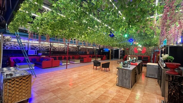 A spacious indoor area with seating arrangements, a reception desk, and a television screen. - Le-Leisure Hotel (Prayagraj)