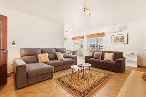 A living room with two sofas, a coffee table, and a patterned rug. - Casa Tita, sea view, sleeps 6 (Lagos)
