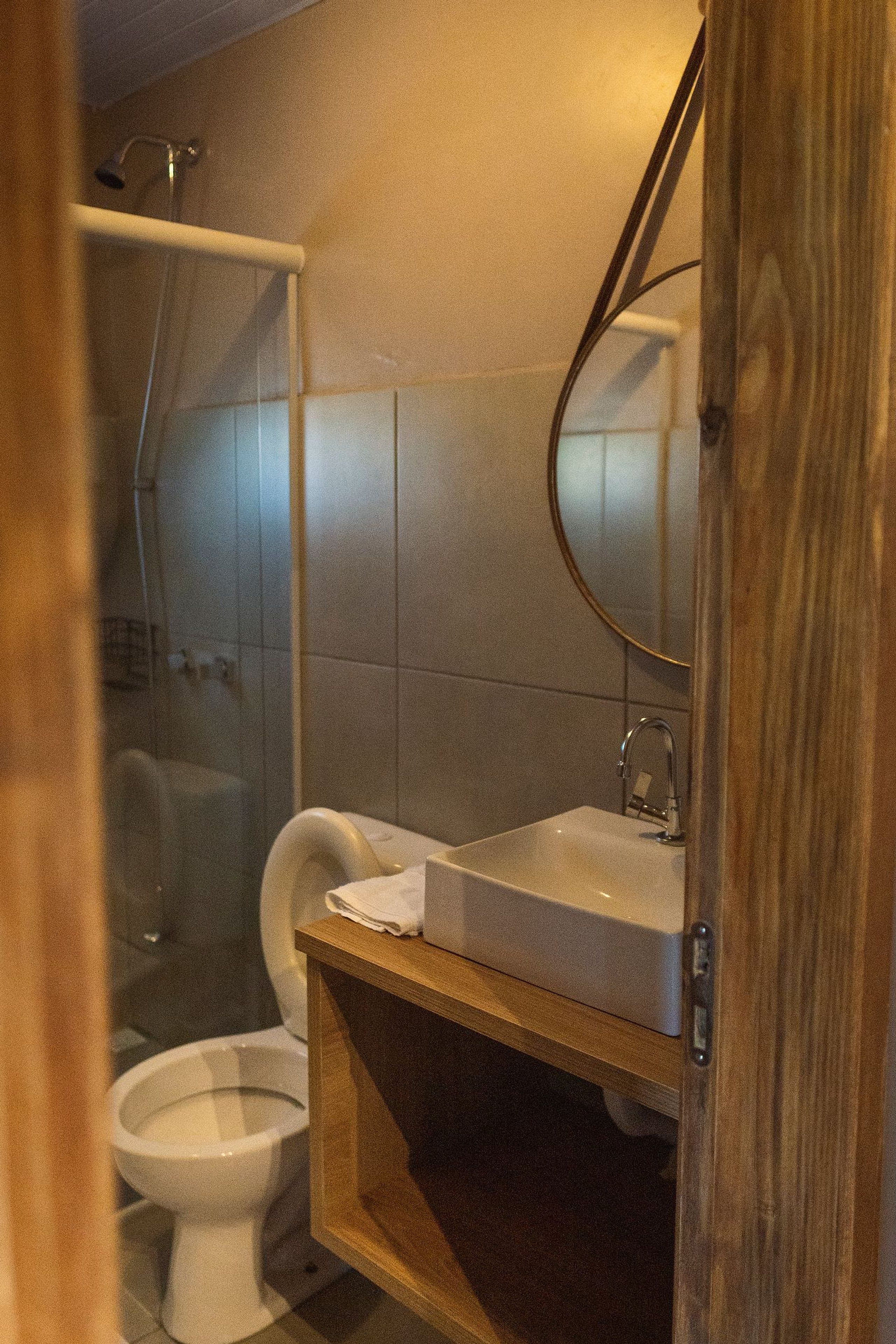 A bathroom with a shower, toilet, and sink.