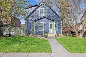 A two-story house with a front porch, a small front yard, and a tree. - PLATTinum Haven, In town 3 bedroom 3 bathrooms with hot tub (Red Lodge)