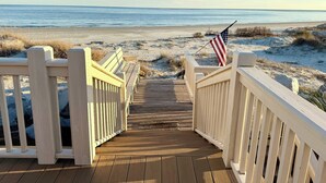 A wooden boardwalk leading to a beach with an American flag. - Oceanfront, Private beach access, Golf Cart Included - 799 Marlin Drive (Fripp Island)