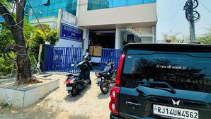 A building with a sign reading 'Radha Ratan Inn' and a parked car in front. - Hotel Radha Ratan Inn (Jaipur)