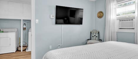 Sink into crisp linens and unwind in your serene bedroom retreat, complete with a wall-mounted TV, in-room laundry, and refreshing air conditioning for ultimate comfort.