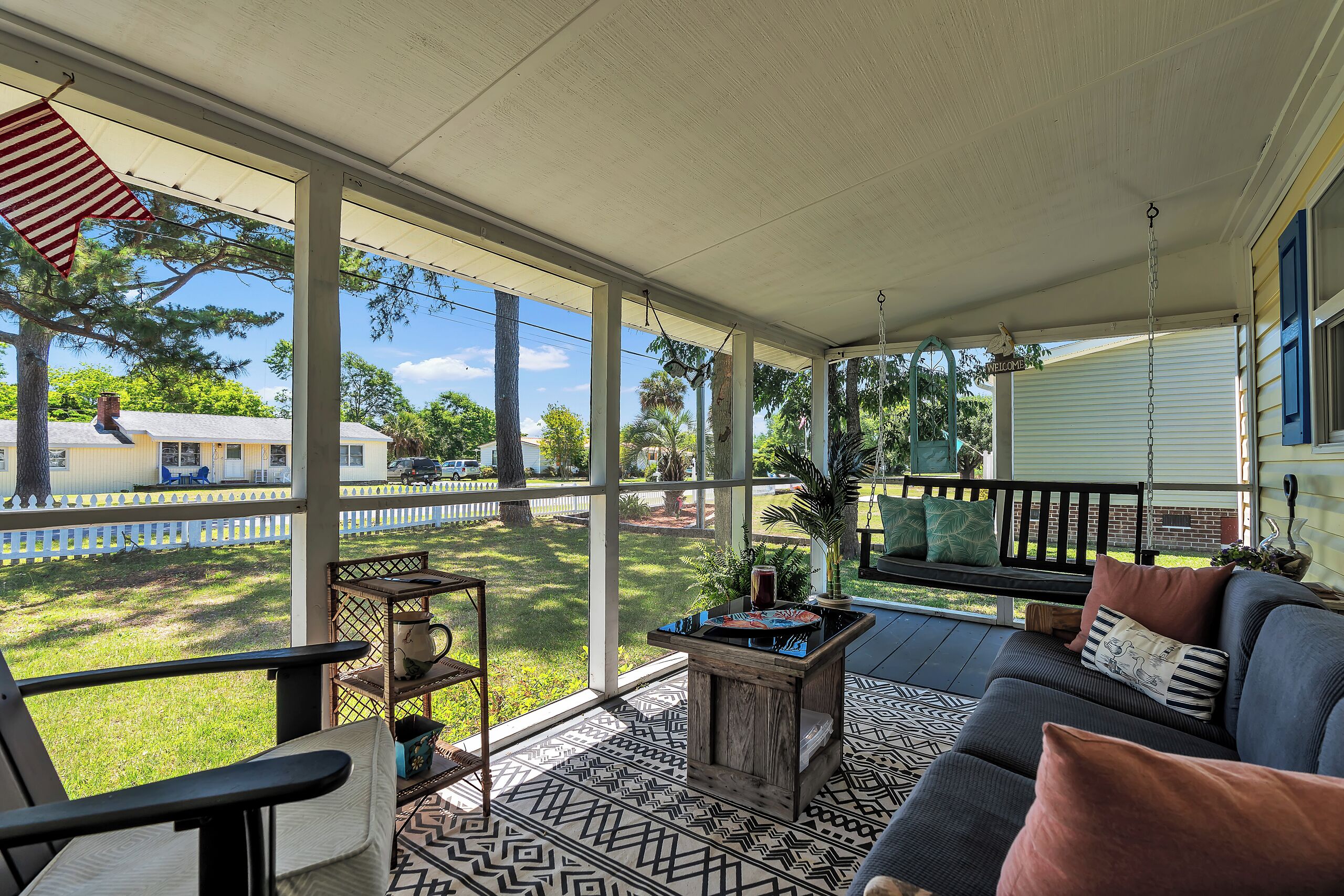 Relax on your private screened porch with garden views, complete with a cozy swing and comfortable seating—perfect for morning coffee or unwinding after a day of exploring.
