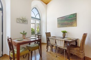 A dining area with a table, chairs, and a window with a view.