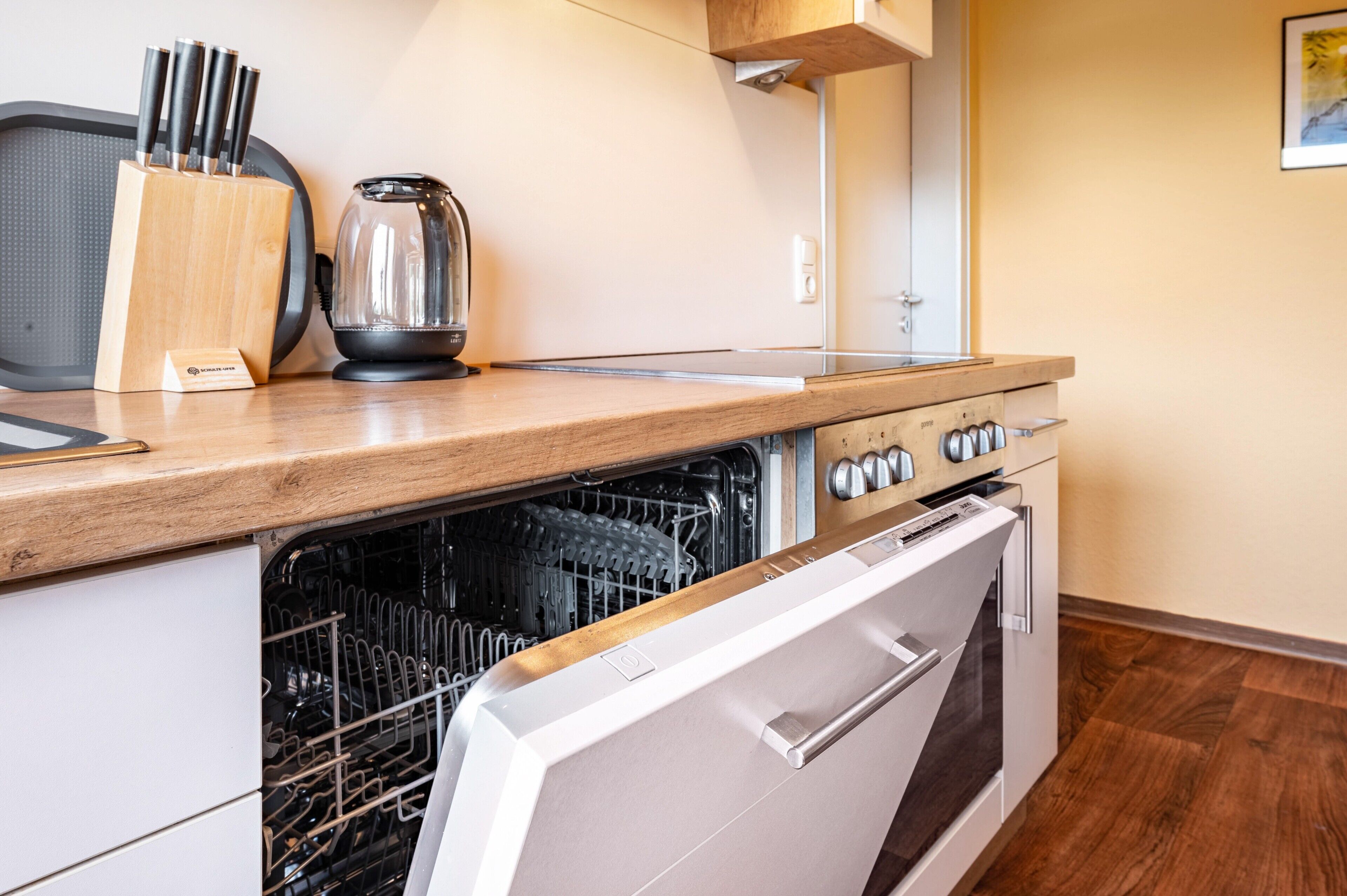 Fridge, stovetop, dishwasher, coffee/tea maker