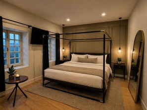 A four-poster bed in a bedroom with a window, bedside table, and mirror. - Boutique Old Montreal Suite-1C (Montreal)