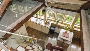 Ein geräumiges Loft mit einer Glasdecke, einem Essbereich und einer gemütlichen Sitzecke.