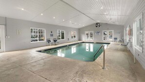 A swimming pool with a tiled deck, lounge chairs, and safety signs. - Cozy 2 Bed 2 Bath Condo! Gated Waterway Community in Myrtle Beach (Myrtle Beach)