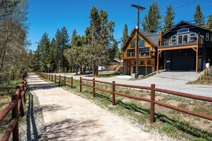 Une cabane en bois avec un garage et une véranda couverte.