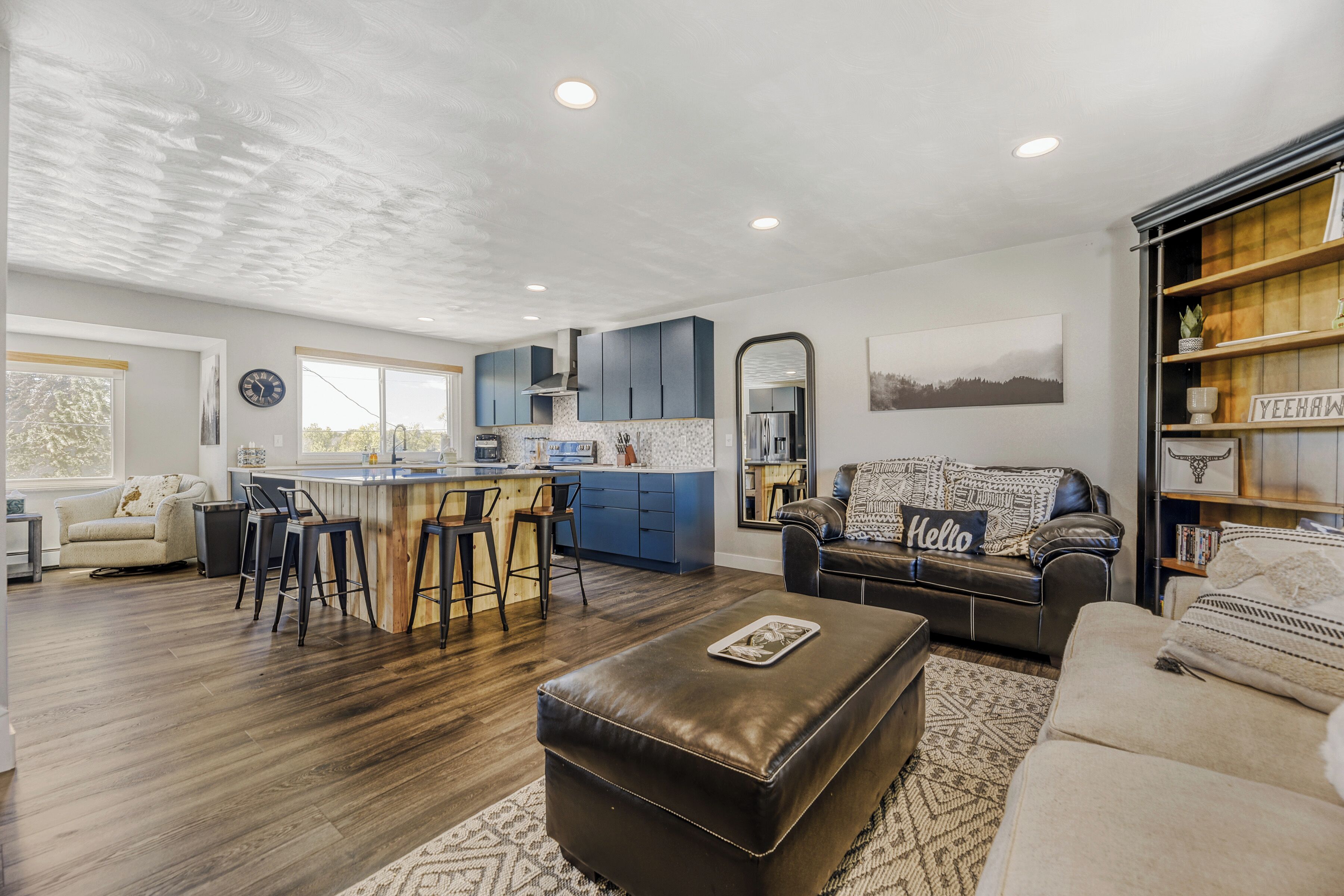 Sink into plush leather seating or gather around the rustic dining bar in this open, light-filled space where modern design meets warm, natural textures—perfect for your group getaway.