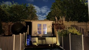 A backyard with a small shed, a paved area, and a wooden fence. - 2 Bedroom With Electric Charging and Parking (Gillingham)