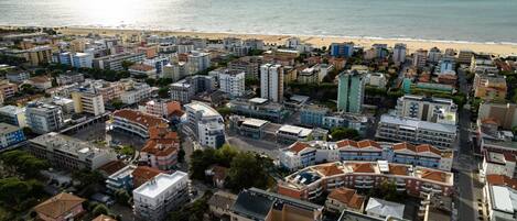 An aerial view of a coastal city with a beach in the background.