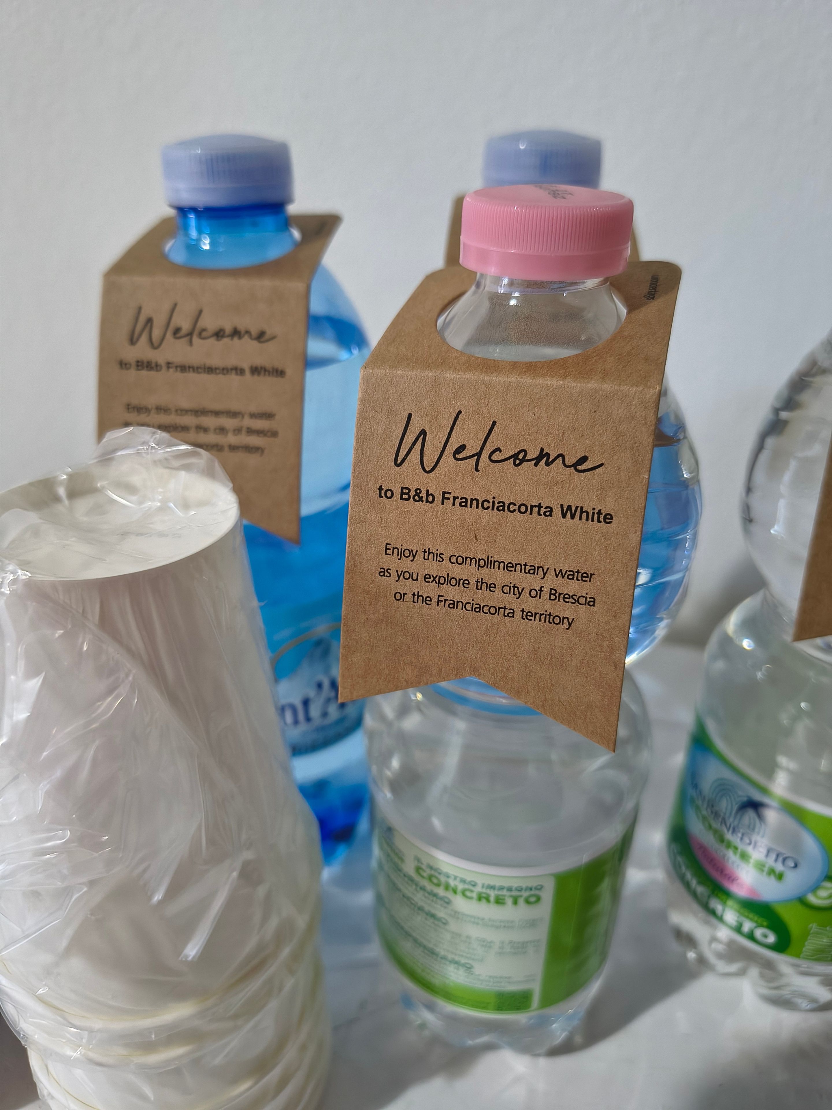 Bottled water with labels and a welcome sign.