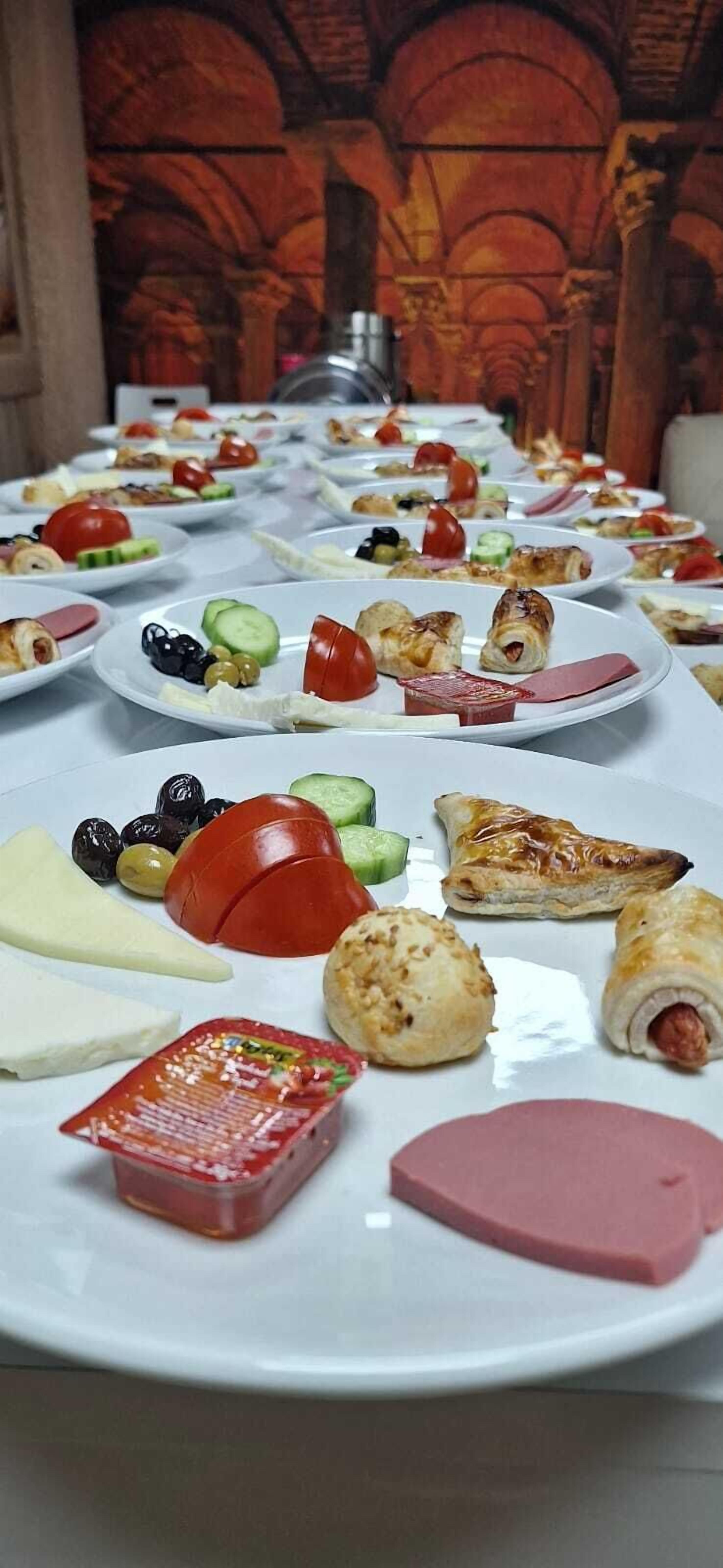 A table with various food items, including pastries, cheese, and vegetables.