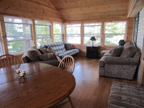 Living area - Cozy, peaceful cottage on quiet lake.  Relax and unwind with a 180 lake view. (Arden)