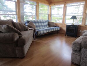 Living area - Cozy, peaceful cottage on quiet lake.  Relax and unwind with a 180 lake view. (Arden)