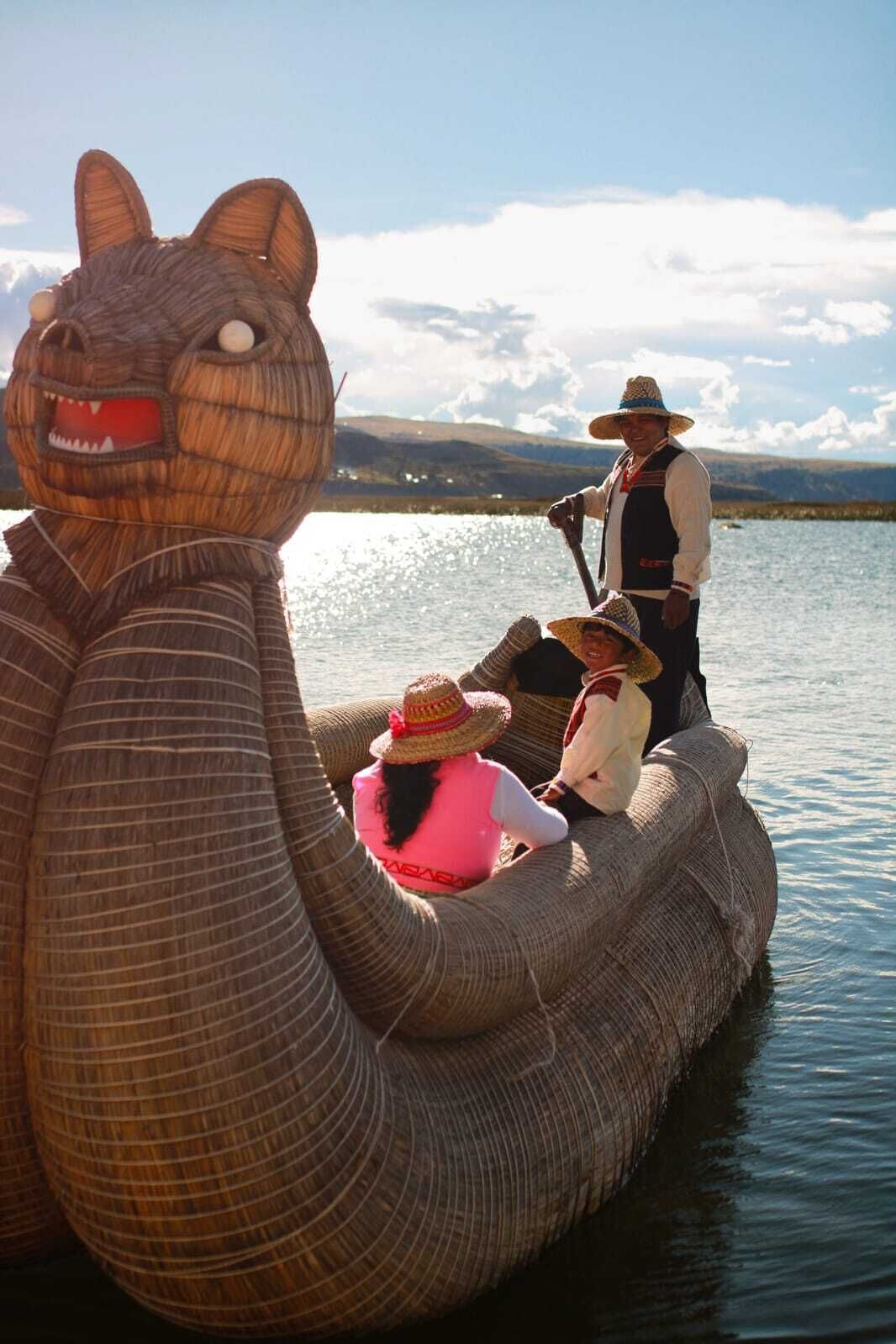 A large, animal-shaped boat with people on it.