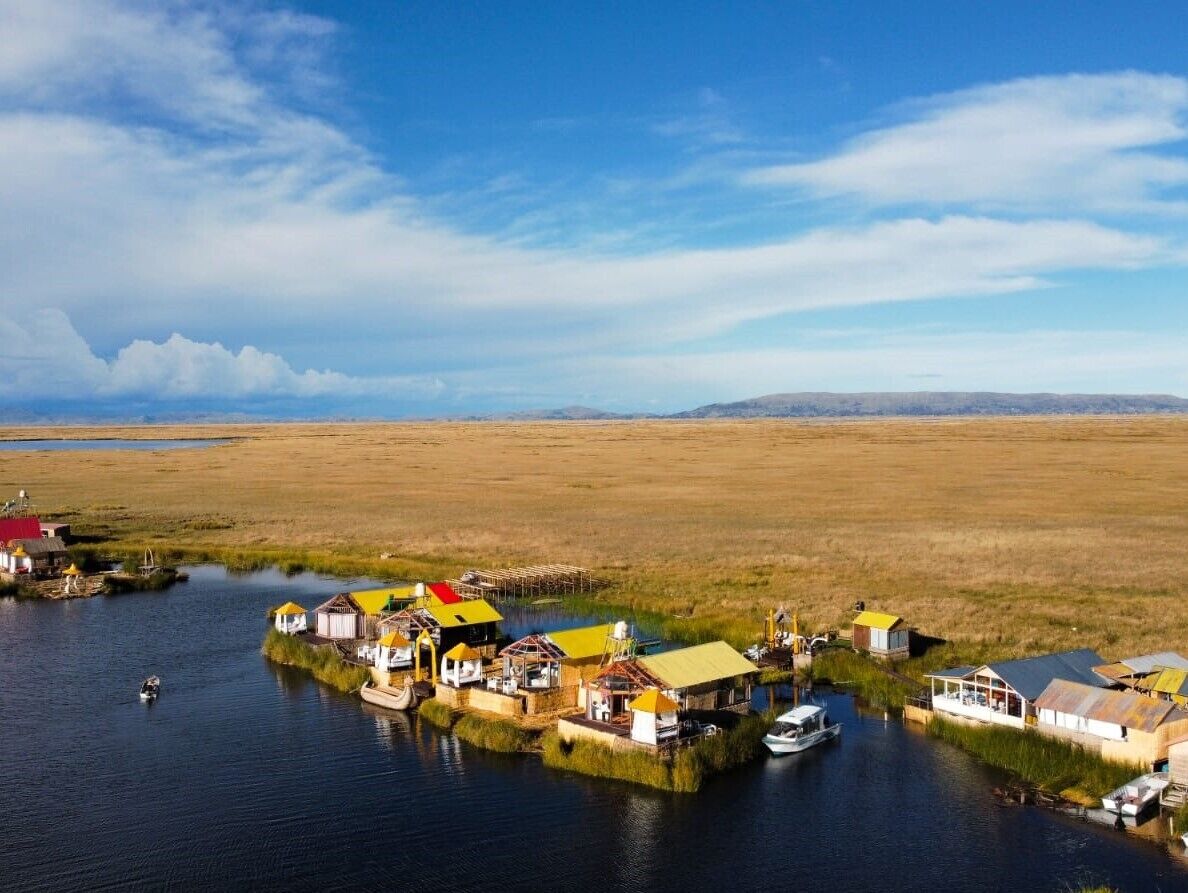 A floating structure with multiple buildings, connected by walkways over water.