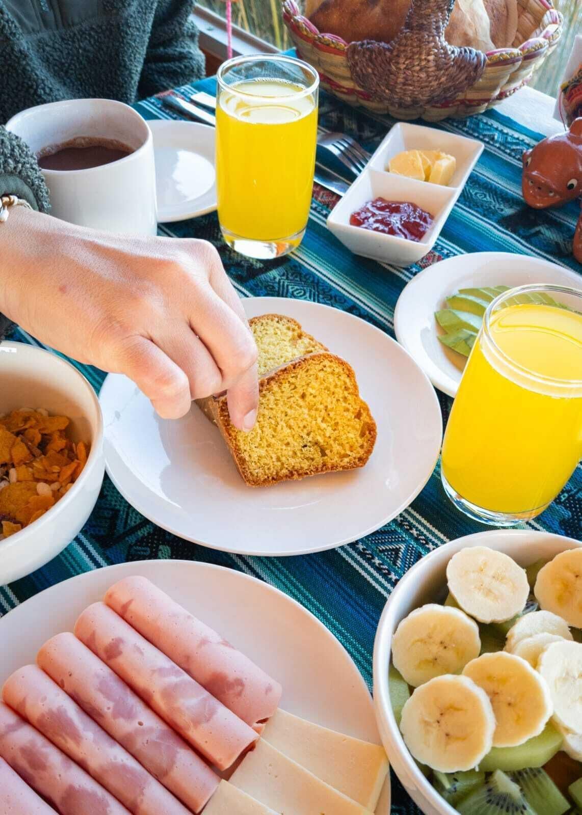 A breakfast setting with toast, fruit, and beverages on a table.