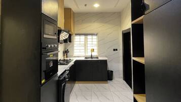 Junior Apartment, Balcony, City View | Private kitchen | Fridge, microwave, oven, stovetop