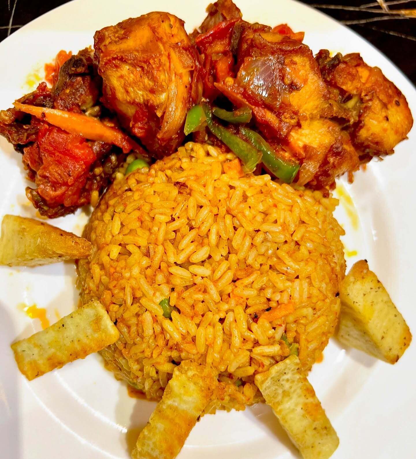 A plate of food with rice, chicken, and vegetables.