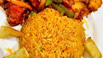 A plate of food with rice, chicken, and vegetables.