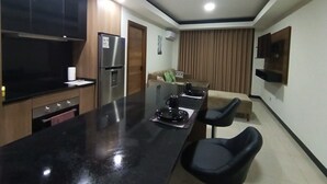A modern kitchen with a black countertop, stainless steel appliances, and a built-in oven. - Comfort in the best area of Santa Cruz—perfect for business travelers and tourists!! (Santa Cruz de la Sierra)