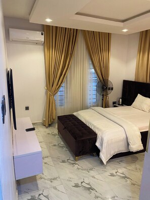 In-room safe, desk, laptop workspace, blackout curtains - Sporshe Hospitality (Abuja)