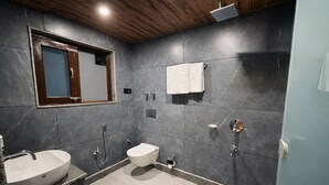 A modern bathroom with a sink, toilet, shower, and a mirror. - Hotel Mustard INN Pahalgam (Anantnag)
