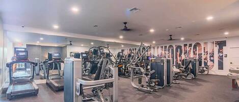 A gym with treadmills, weight machines, and exercise equipment.