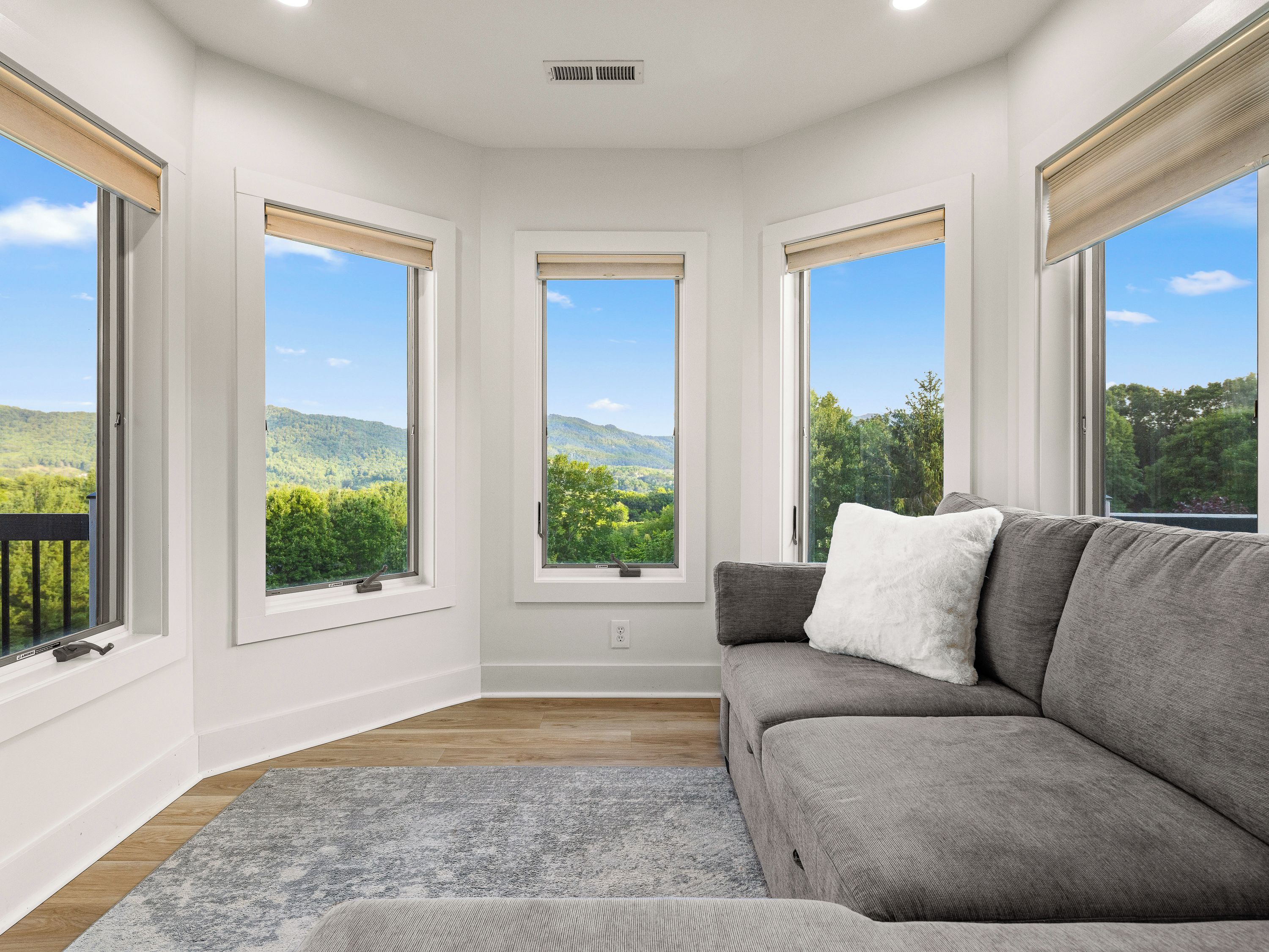 Private sitting area surrounded by windows offers a peaceful place to read, relax, or enjoy the mountain scenery.